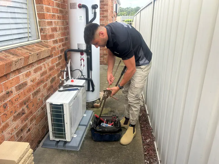 Ben servicing an aging hot water system for a Cambridge Park home