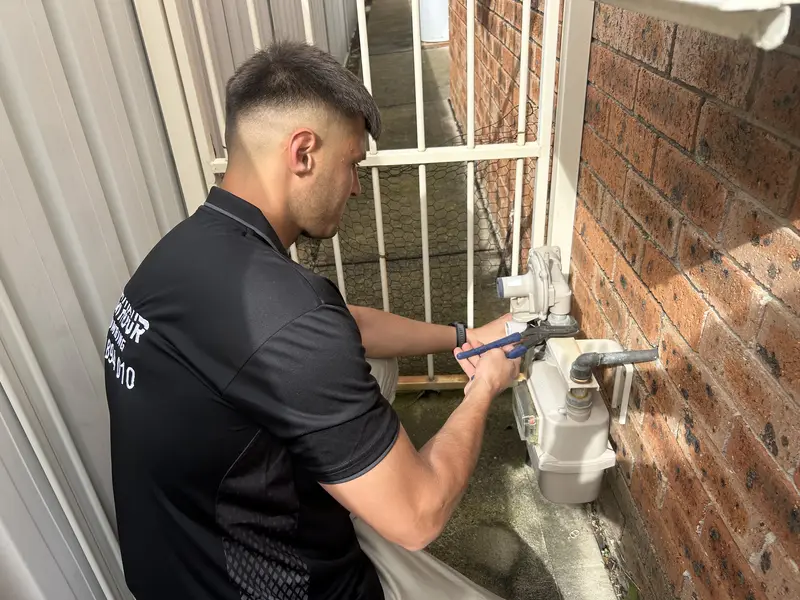 Ben working on a gas appliance connection